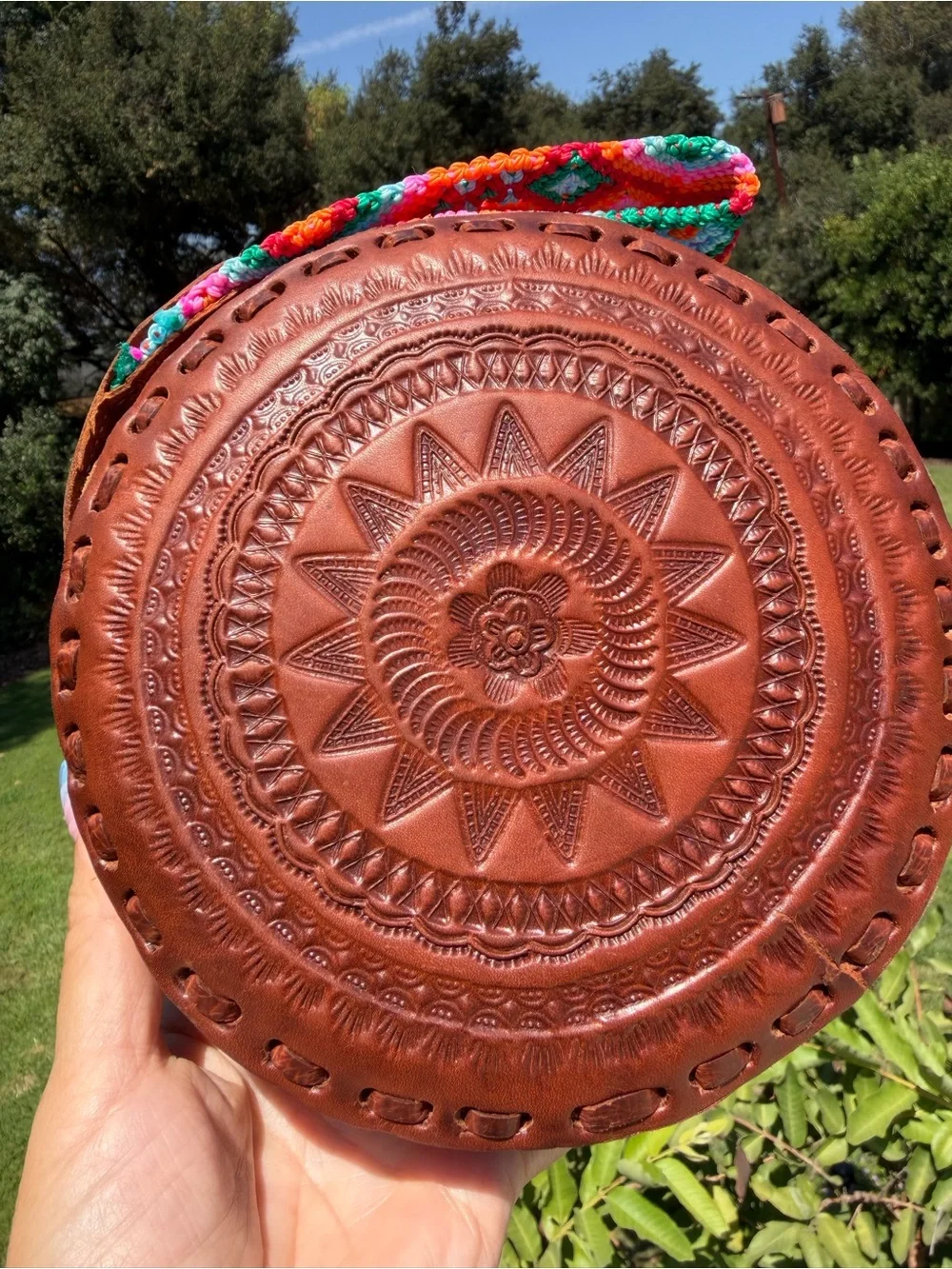 Hand-Tooled Round Leather Wristlet Bag with Colorful Woven Strap